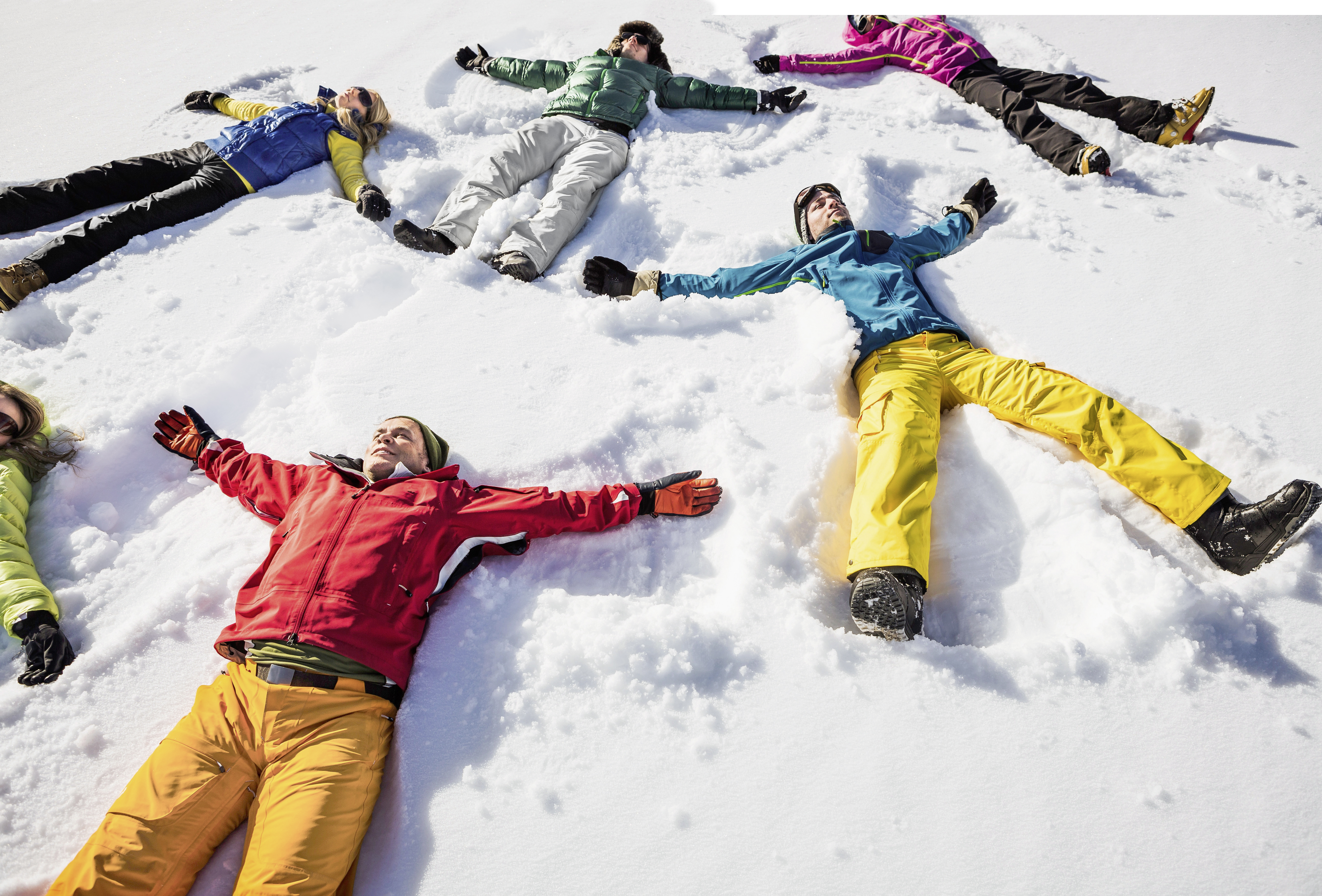 Group of friends doing snow angels